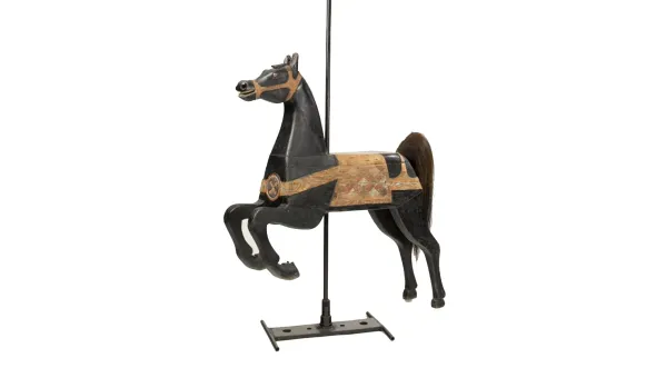 A black and gold painted wooden carousel horse