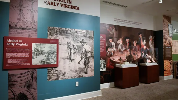 A gallery view of the Cheers, Virginia! exhibition with graphics and artifacts related to beverage history in Virginia