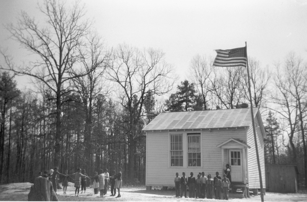 One room Doswell Elementary School for African American children with an American flag visible next to the structure, Hanover County