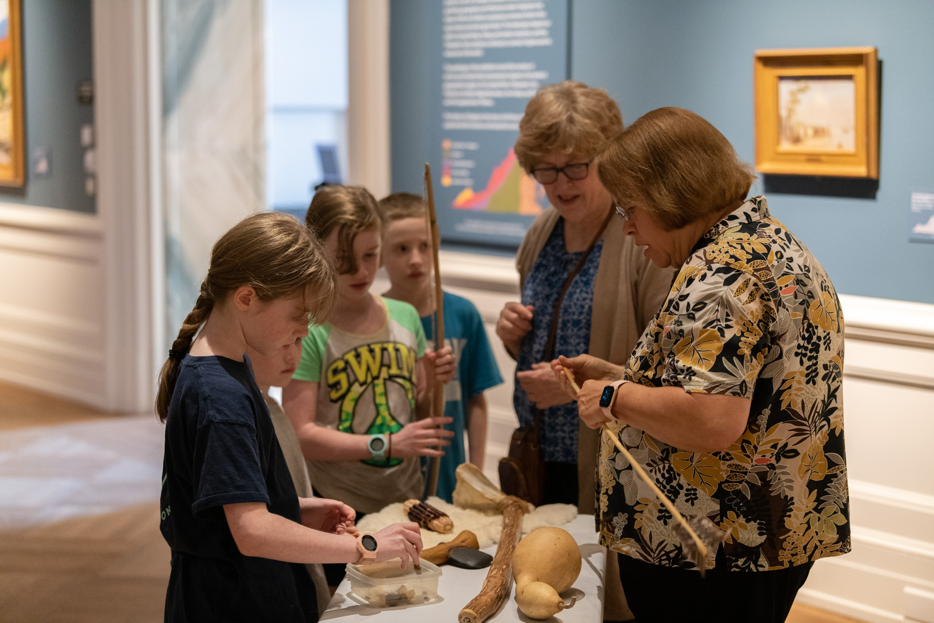 A family looks at artifact replicas with VMHC staff
