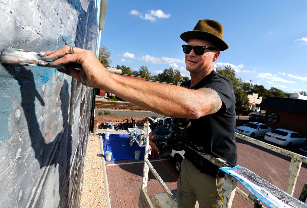 Ed Trask works on a mural.