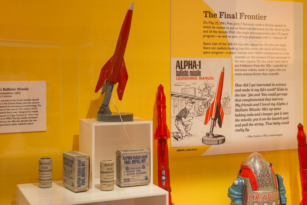 The Alpha-1 Ballistic Missile toy in a display case with wall labels
