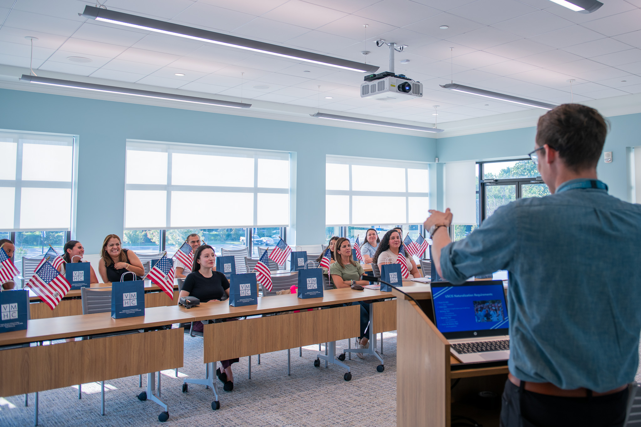A teacher stands at the front of a class of students