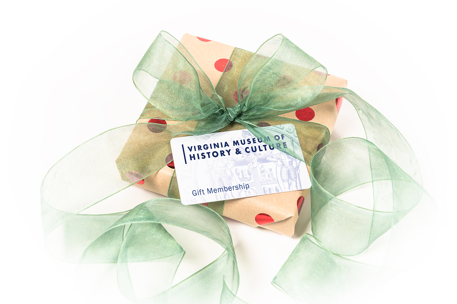 A wrapped box with ribbon has a gift card on top of it that says Virginia Museum of History & Culture Gift Membership
