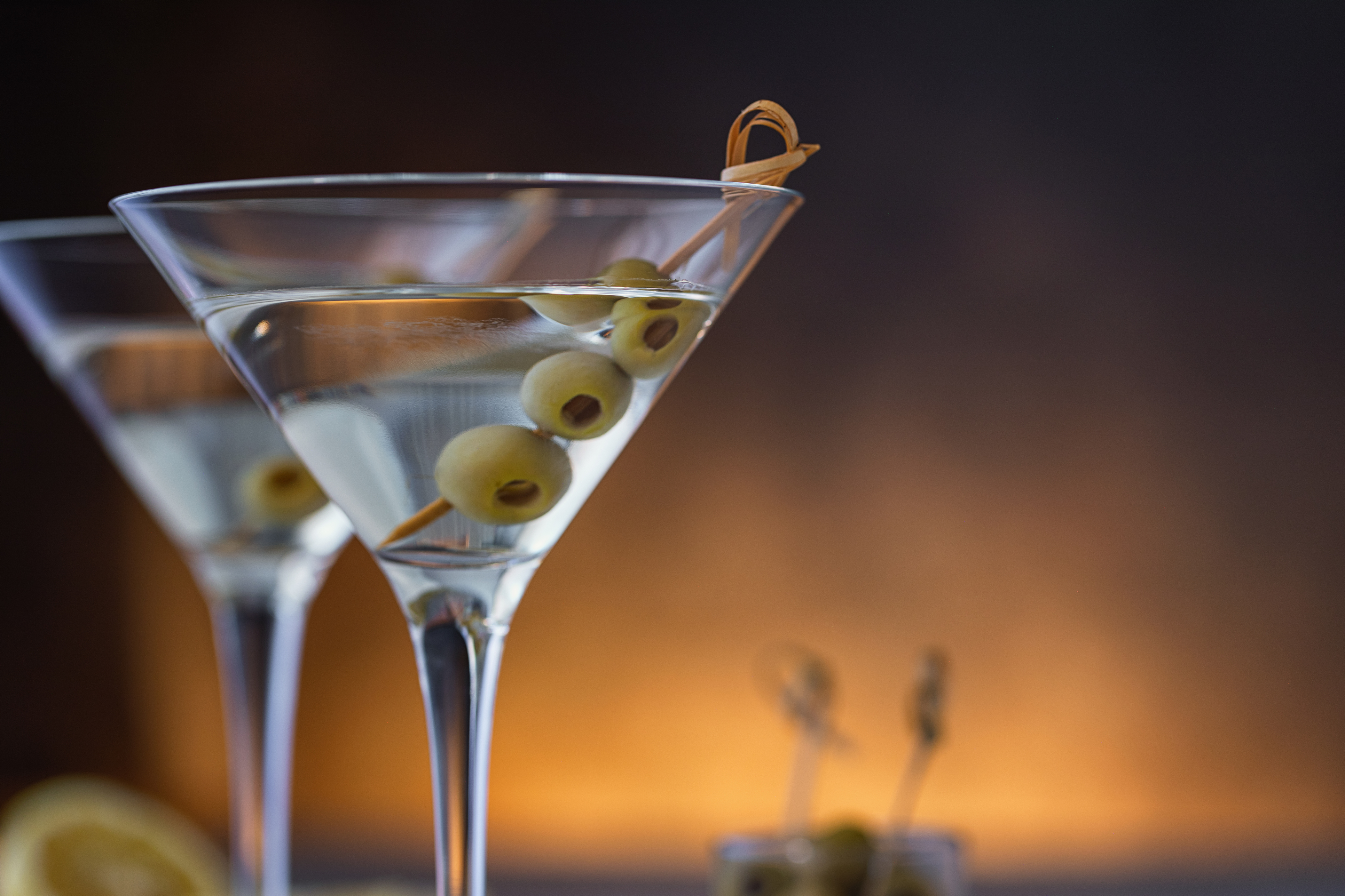 Two martini glasses with olives