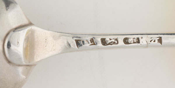 Engraved marks on a silver spoon