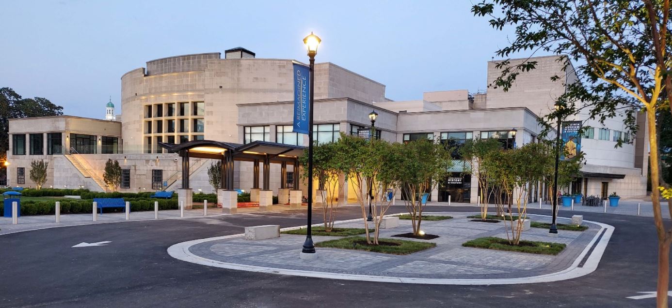 An evening photo of the guest entrance and plaza at the VMHC