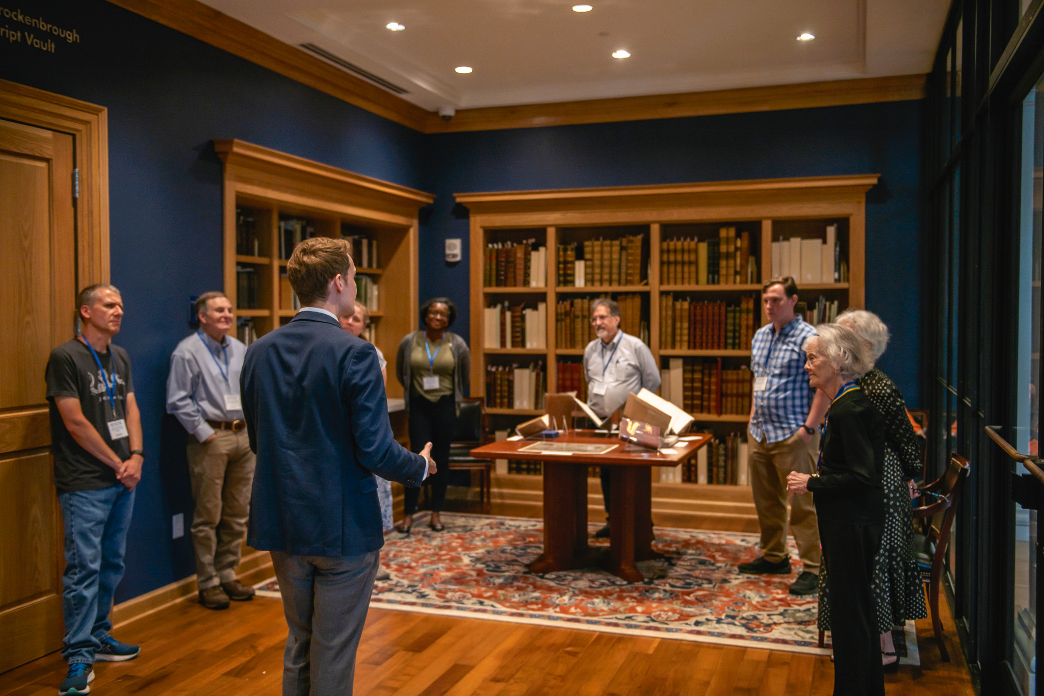 A group of people tour the library at VMHC