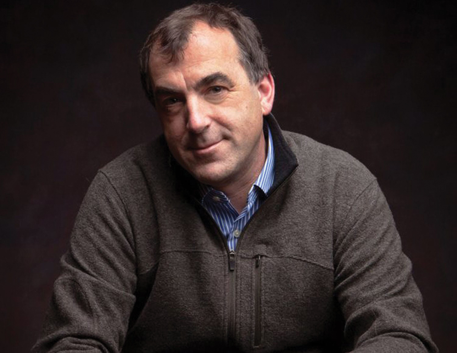 Headshot of Alex Kershaw - a white man with greyish-brown hair in a grey sweater