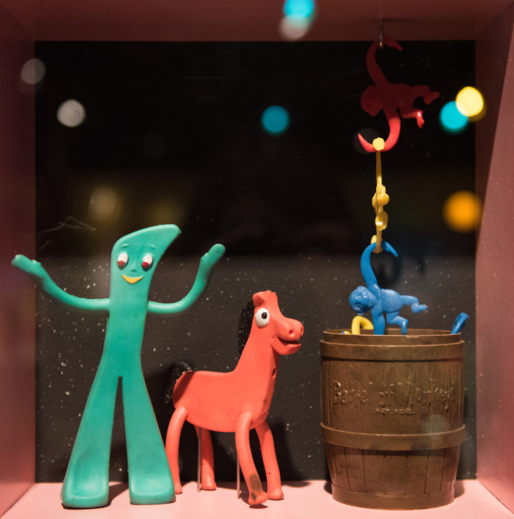A close-up of Gumby and Pokey toys in a display case