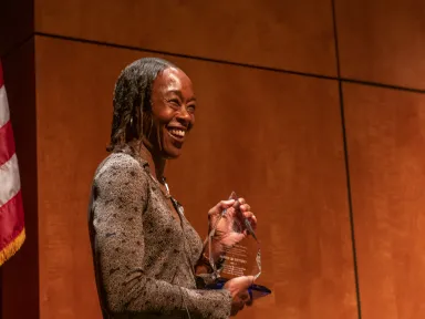 Author, Margot Shetterly, accepts an award on stage at the VMHC