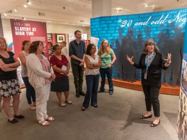 A group takes a tour of the Determined exhibition 
