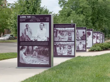 Photo panels line the sidewalk in front of the museum