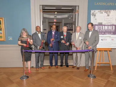 Sponsors and partners cut the ribbon to open the Determined Exhibition in 2019