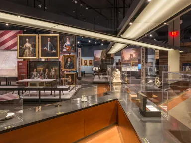 Story of Virginia Gallery in VMHC. View shows colonial portraits in background and glass cases in foreground