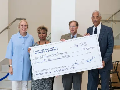 Grant winners post with giant check