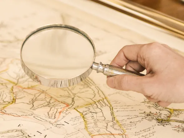 Magnifying glass  being held over a map