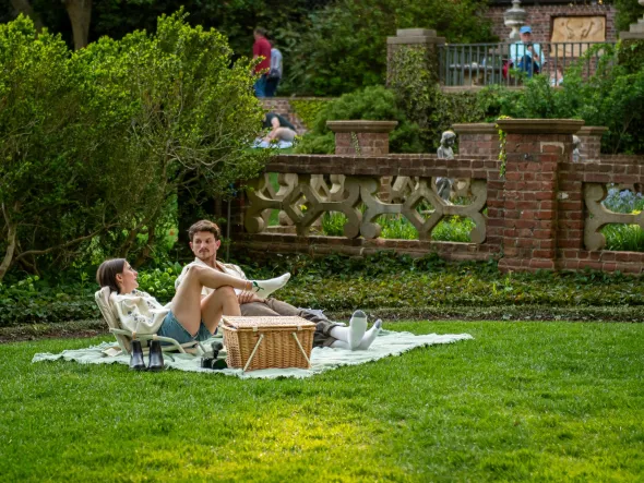 Member Mondays A young couple picnics in the lush gardens of the Virginia House.