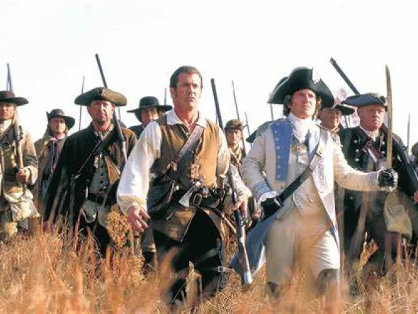 Movie still from "The Patriot" featuring Mel Gibson dressed in colonial war attire fighting the British.