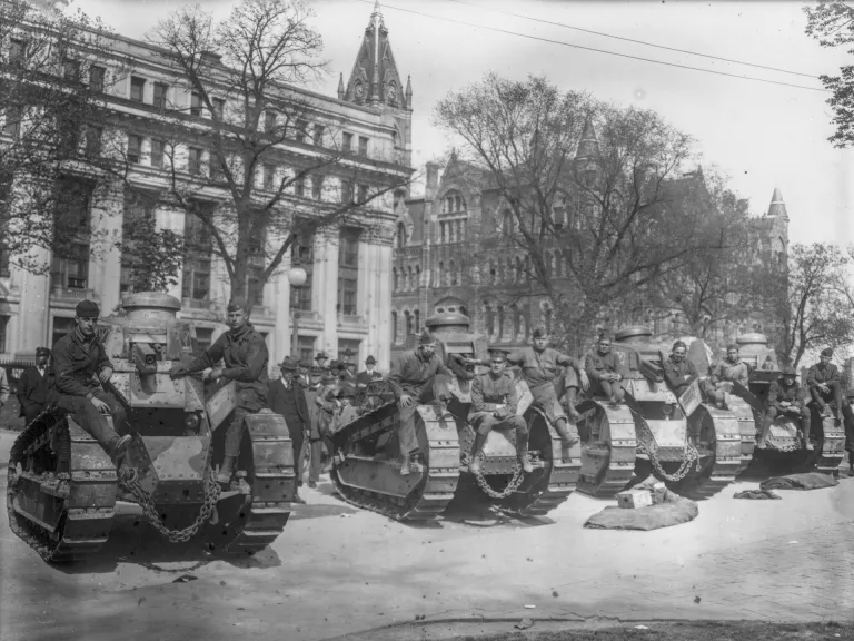 WWI tanks Black & White photo of a row of tanks in front of a building circa 1912-1914