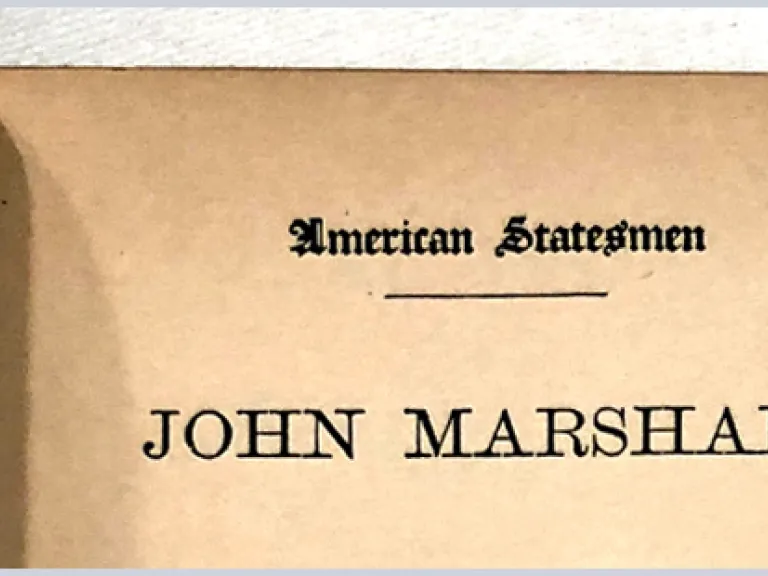 An open book with text: American Statesman: John Marshall