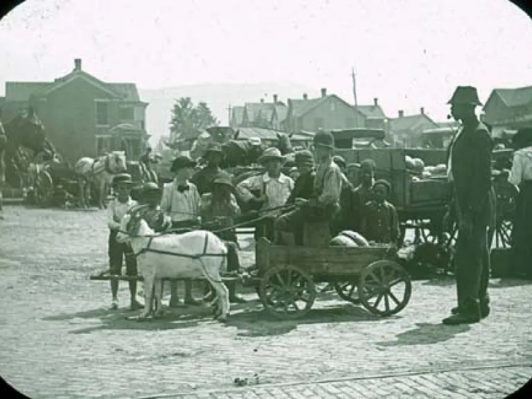 Street scene, goat cart and children.