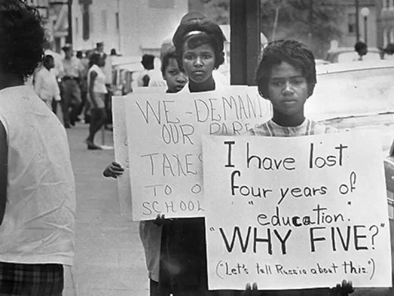 Teenagers protesting school closings Historic photograph of two black teenage girls protesting school closings