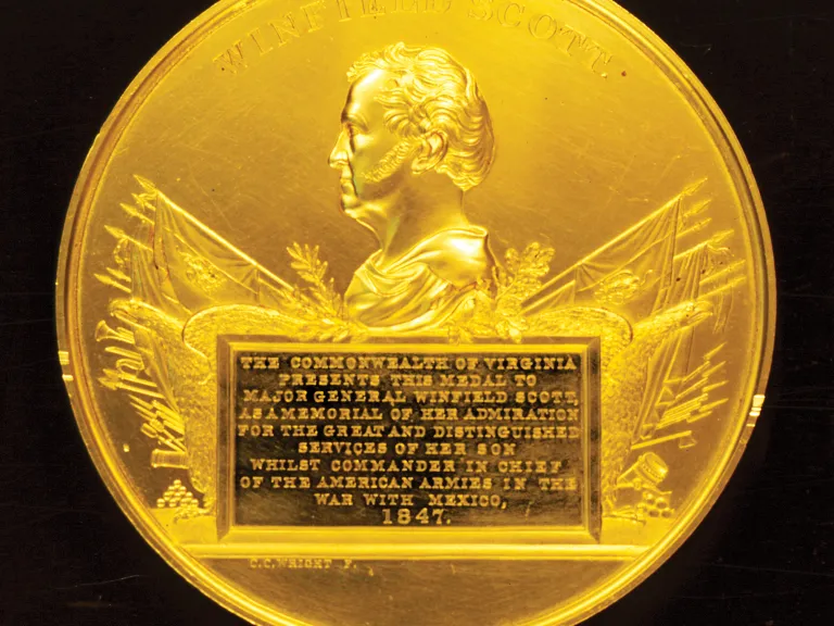 A photograph of a gold medal.
