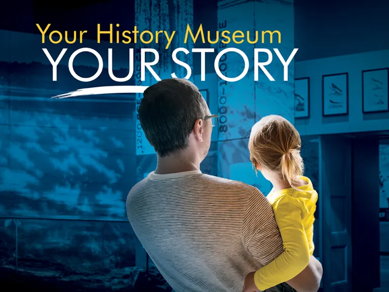 VMHC: Your History Museum, Your Story A parent holds a child as they look into a museum exhibition. Above their heads are the words: Your History Museum, Your Story