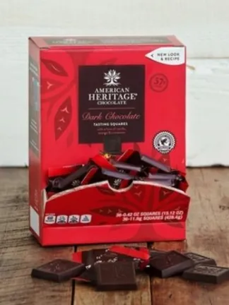 A red box of American Heritage Chocolate squares on a wooden table