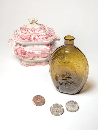 Bowl that celebrates the candidacy of William Henry Harrison, whisky bottle that is embossed with images of Zachary Taylor and George Washington, clothing button that celebrates George Washington's inauguration, and medal that celebrates the presidency of John Tyler
