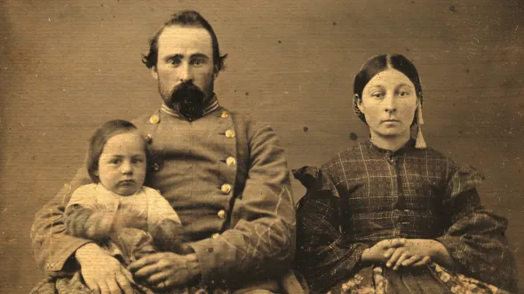 A sepia photo of a family in Civil War attire