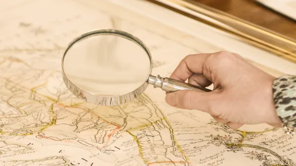 Magnifying glass  being held over a map