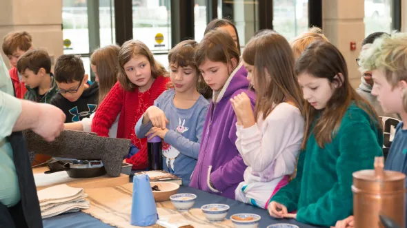 Students participating in a demonstration of historic chocolate making Students visit the VMHC for a tour