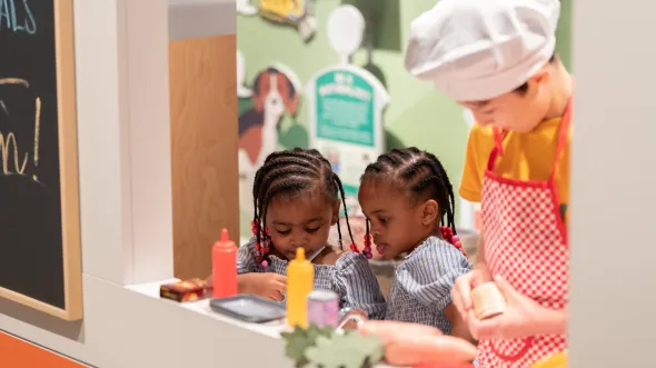 Children play with toy food in an interactive food truck exhibition