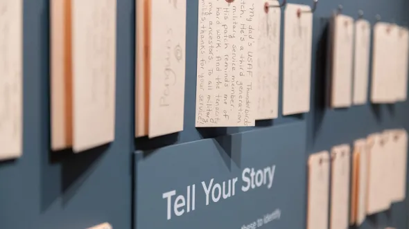 Hanging tags with handwriting in an interactive with instructions to Tell Your Story