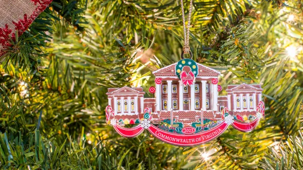 2023 Ornament An ornament hanging on a tree of a gingerbread house depiction of the Virginia State Capitol