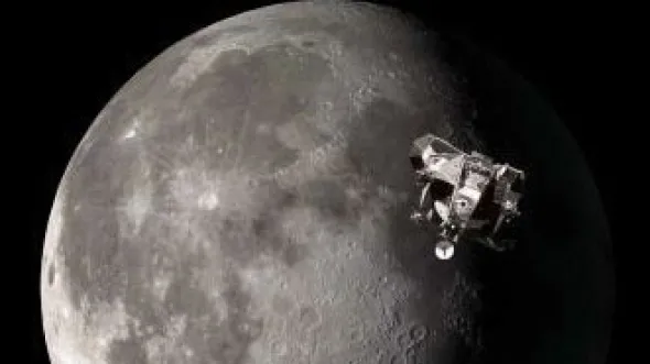 A photo of the moon with a spacecraft flying in front of it
