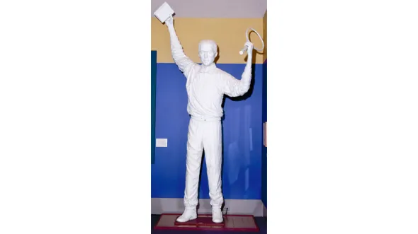 Arthur Ashe statue with him holding a tennis raquet aloft.