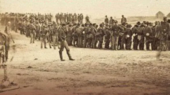A sepia toned photo of military troops lined up