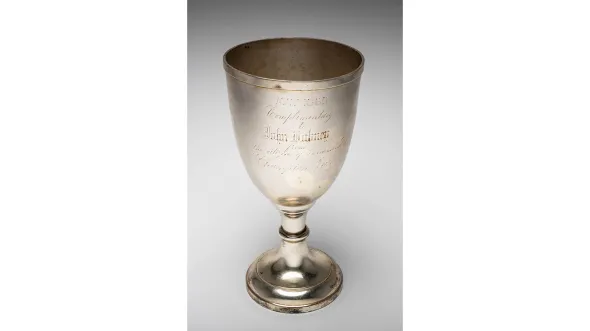 A silver goblet with the name John Dabney engraved on it