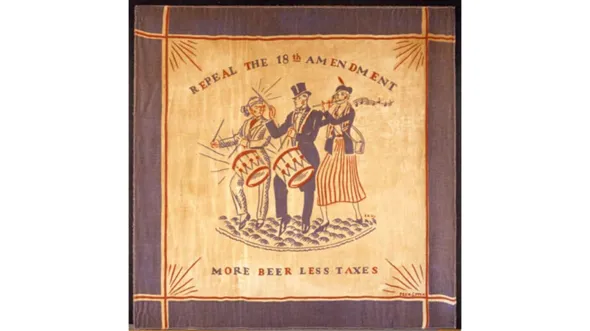 A square scarf with a blue border and an illustration of three people in the center, two of whom play handheld drums and 1 of whom plays a flute. Words read "Repeal the 18th Amendment: More Beer Less Taxes"