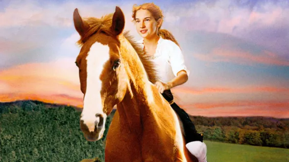 A young girl rides a horse