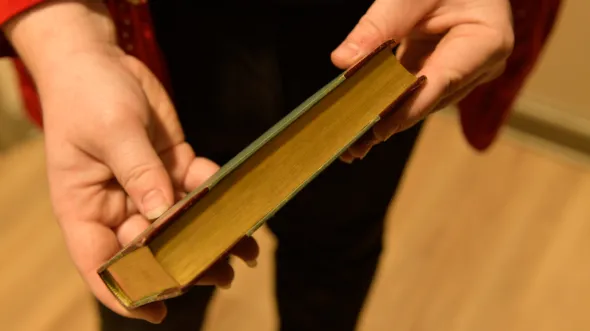 A closed book shows a plain spine
