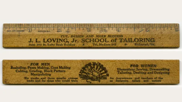 Wooden ruler with text "J.L. Loving, Jr. School of Tailoring"