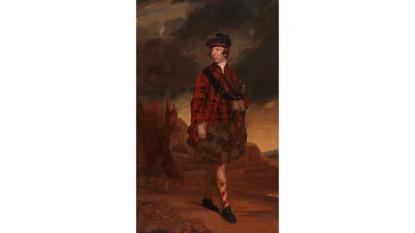 A man in red plaid Scottish garb walks through a landscape
