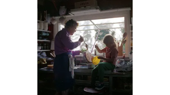 Julia Child and Merida cook in a kitchen