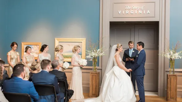 Bride and groom during ceremony in landscape gallery at the VMHC
