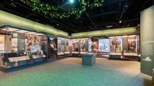 An exhibition section about Shenandoah Valley features artifacts and photographs of the region, including mountain hikes, agriculture, and cultural textiles