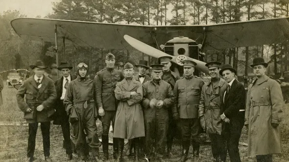 Photograph of Lt. Sylvanus Ingram and an early biplane, about 1918–1920 (VHS 2006.177.1_v1)